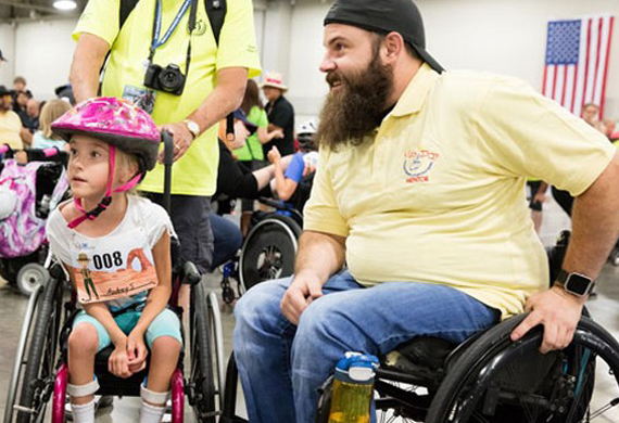 image of Dan Rose talking with disable girl in a wheelchair